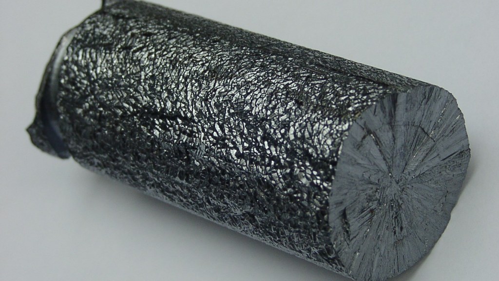 A gray, rough-surfaced rod of hyperpure polycrystalline silicon.