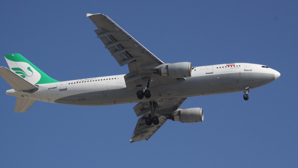 A Mahan Air passenger jet on the tarmac at an airport.