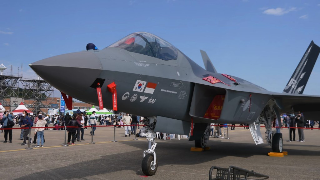 A gray KF-21 Boramae fighter jet prototype parked on the tarmac at an air show.