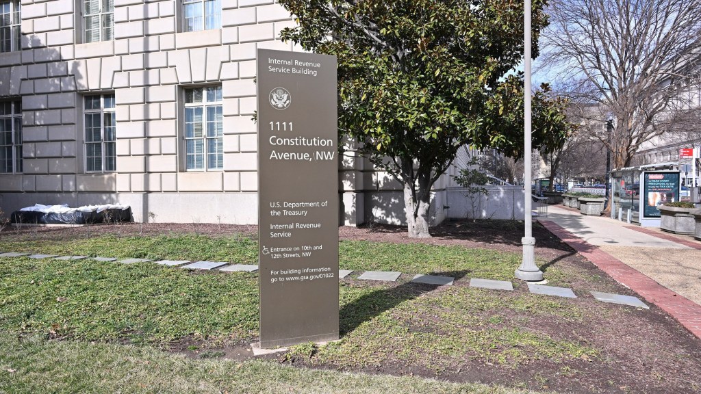 A sign reading Internal Revenue Service mounted on the stone wall of the IRS building in Washington, D.C.