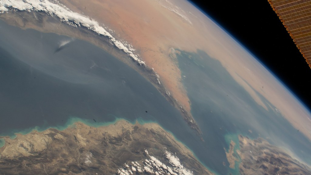 Astronaut photograph of the narrow Strait of Hormuz separating Iran from the Arabian Peninsula.
