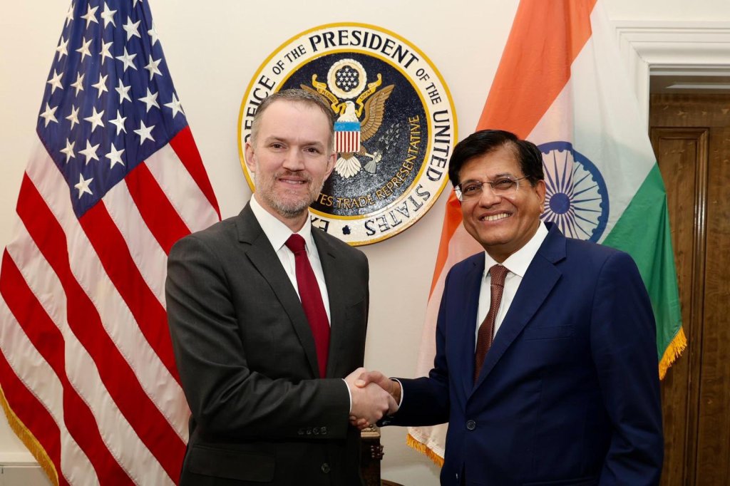 U.S. Trade Representative Jamieson Greer seated beside Indian Commerce Minister Piyush Goyal at a meeting table.